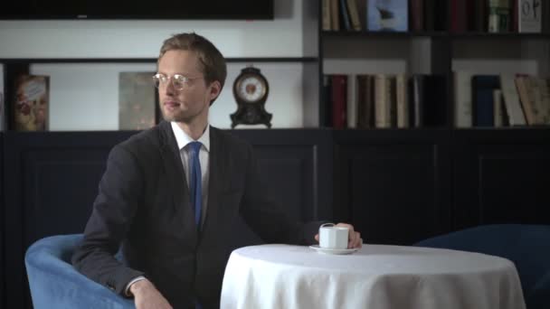 Freiberufler bei einem Kaffee, der im Restaurant auf jemanden wartet — Stockvideo