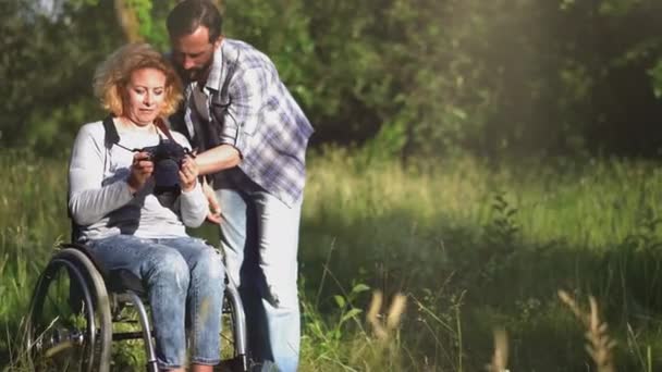 Mujer en silla de ruedas lerning fotografía — Vídeo de stock