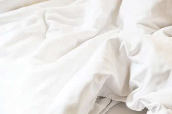 White pillow on bed and with wrinkle messy blanket in bedroom — Stock Photo, Image