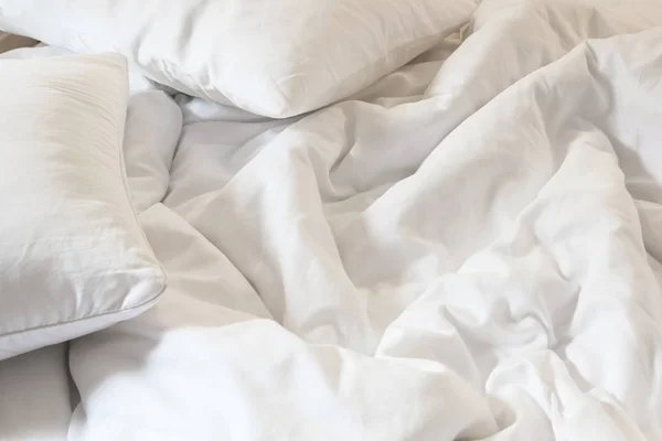Almohada blanca en la cama y con la manta sucia arruga en el dormitorio, de dormir en una larga noche —  Fotos de Stock