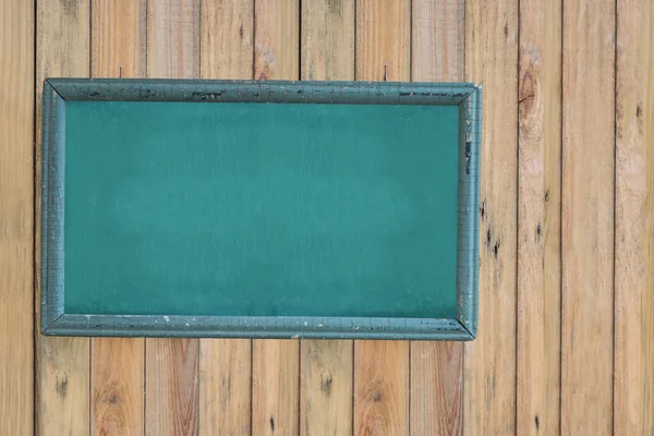 Empty green chalkboard with black wooden frame  on vintage wall wooden — Stock Photo, Image