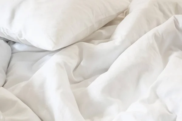 Almohada blanca en la cama y con la manta sucia arruga en el dormitorio, de dormir en una larga noche —  Fotos de Stock