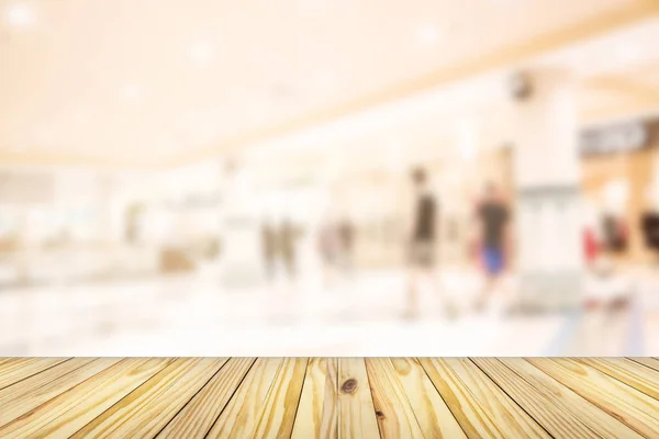 empty wooden front of abstract blur many people shopping in department store, urban lifestyle concept