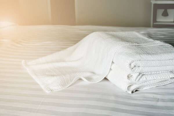white towel on white mattress fabric, with soft light vintage.