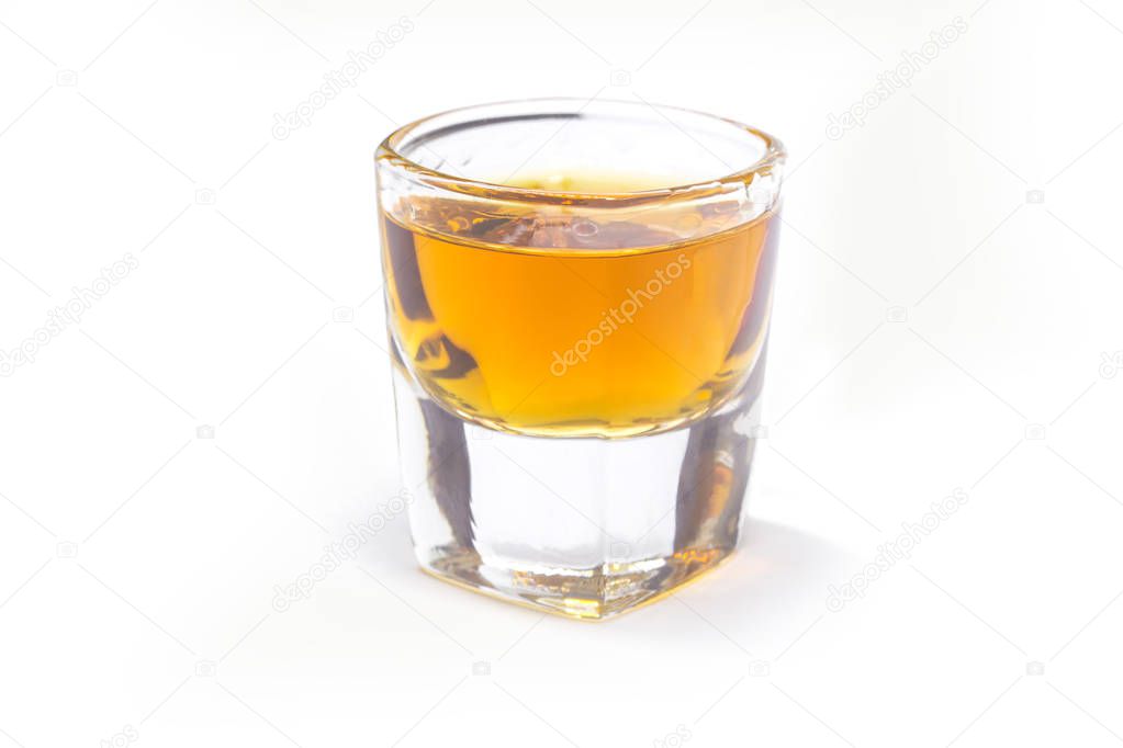 Whiskey shot on white background.