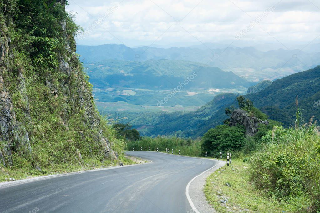 Long And Winding Rural Roads Leading Through Green Hills In Laos