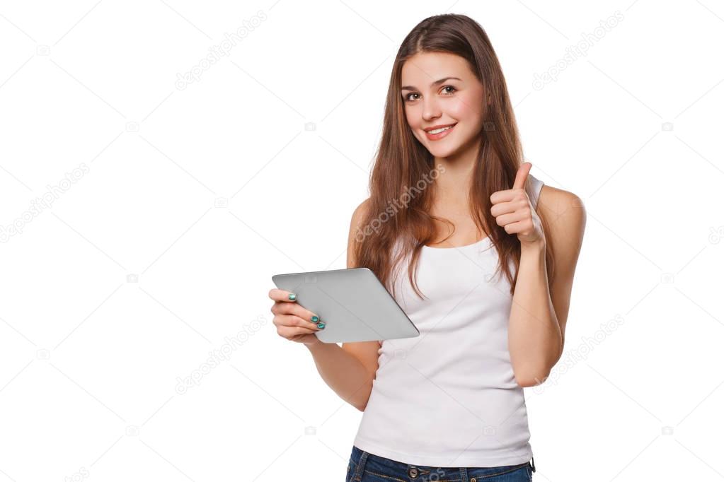 Attractive smiling girl in white shirt using tablet showing thumbs up. Woman with tablet pc, isolated on white background