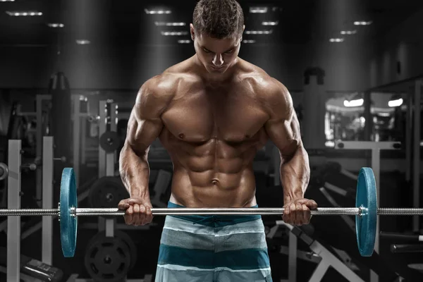 Muskulös man tränar på gym gör övningar med skivstång, stark man naken överkropp abs — Stockfoto