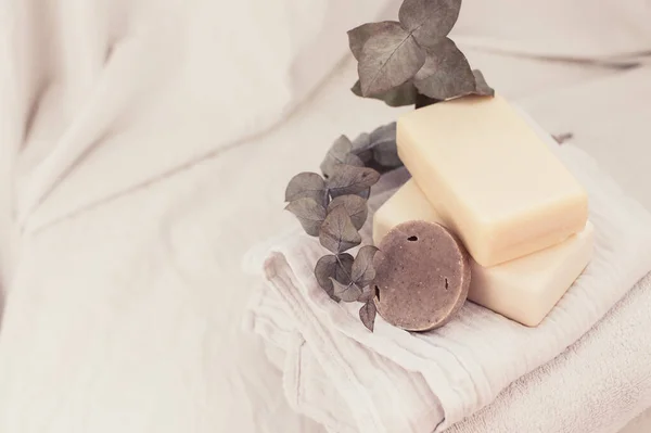 Bars of natural organic soap and towels. Ecological friendly body care products.