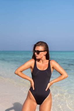 Okyanustaki adalarda siyah mayolu seksi bir kız.
