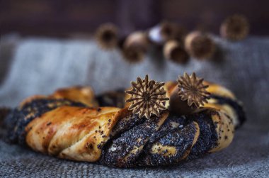 Karanlık bir arka planda haşhaş tohumu rulosu ve çuval bezi