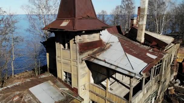 Abandoned ruined house mansion with a tower and chimneys on the coast — Stock Video