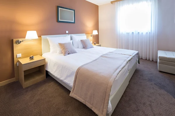 Wnętrza hotelu w sypialni nowoczesne piękne łóżko podwójne — Zdjęcie stockowe