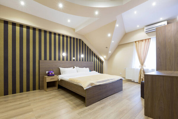 Interior of a new hotel double bed bedroom in the attic