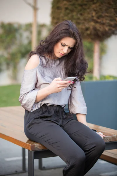 Beautiful woman talking on phone outdoors — Stock Photo, Image