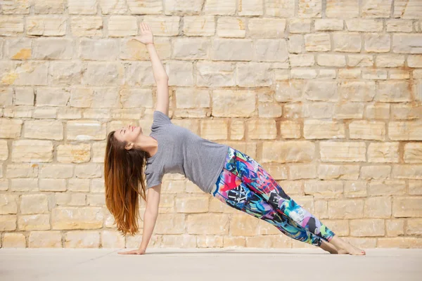 Güzel genç kadın çalışma dışarı, yoga egzersiz yaparak — Stok fotoğraf