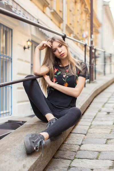 Beautiful woman wearing denim shorts and top outdoors Stock Photo