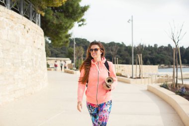 Deniz kenarında yürüyen güzel genç kadın