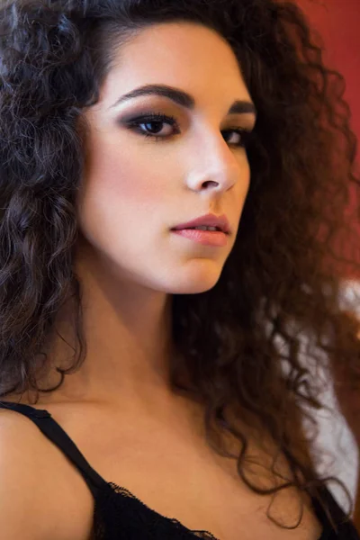 Woman with curly hair poses near window in lingerie — Stock Photo, Image