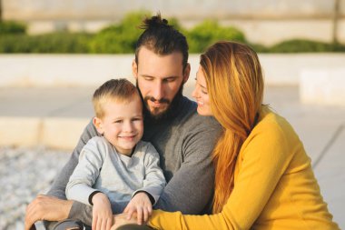 Plajda çocuk ile sonbaharda Çift