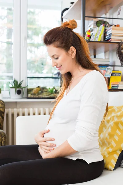 Happy pregnant woman touching her belly — Stock Photo, Image