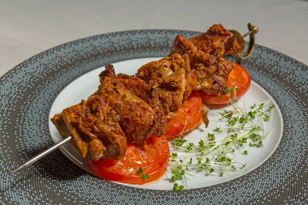 Marinated meat on a stick roasted served on a plate