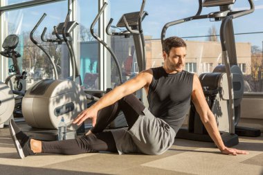 Modern bir spor salonunda egzersiz yapan yakışıklı bir adam.