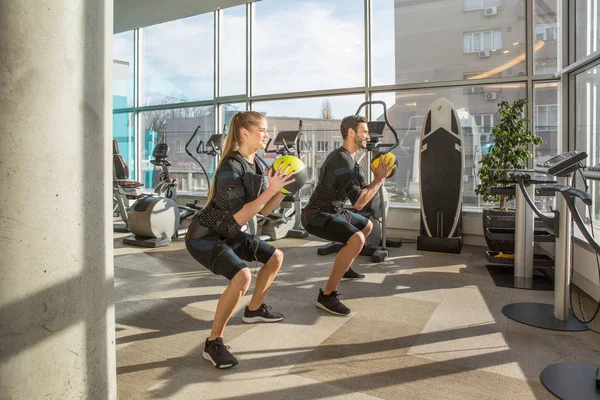 Man en vrouw doen elektromusculaire stimulatie training in een m — Stockfoto