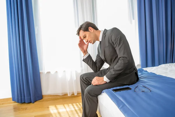 Frustrated Businessman Sitting Hotel Bed Holding His Hand Head — Stock Photo, Image