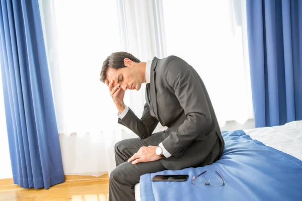 Frustrated Businessman Sitting Hotel Bed Holding His Hand Head — Stock Photo, Image