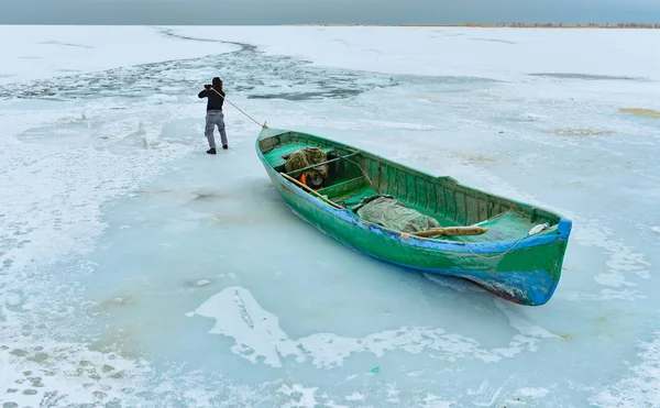 Fishing on the frozen lake with a boat — Stock Photo, Image