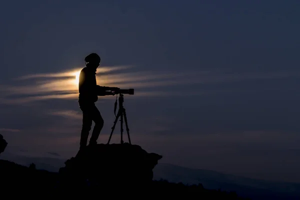 professional photographer preparing on rocky