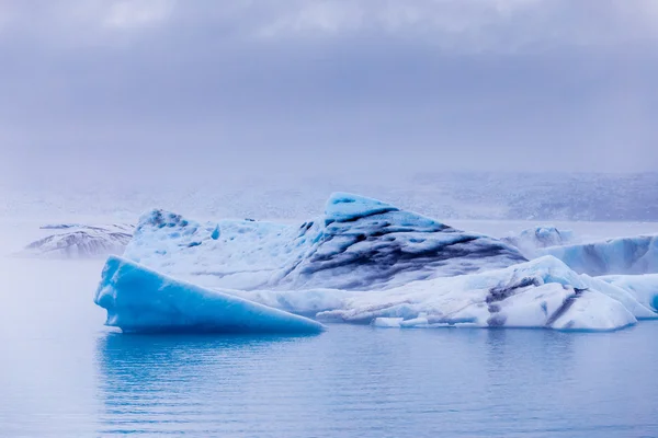 夕暮れ Fjallsarlon 氷河湖に浮かんでいる氷山。手配ラグーンに南 Iceland.Close/夕暮れ Fjallsarlon 氷河湖に浮かぶ氷山. — ストック写真