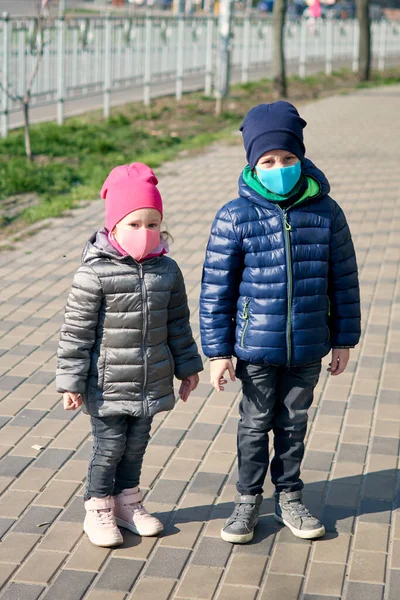 Girl and boy in face mask. Children wear facemask for protect during coronavirus covid-19 epidemic. Virus and illness protection. Safety breathing masks. Coronavirus flu virus concept. Health care and medical concept.