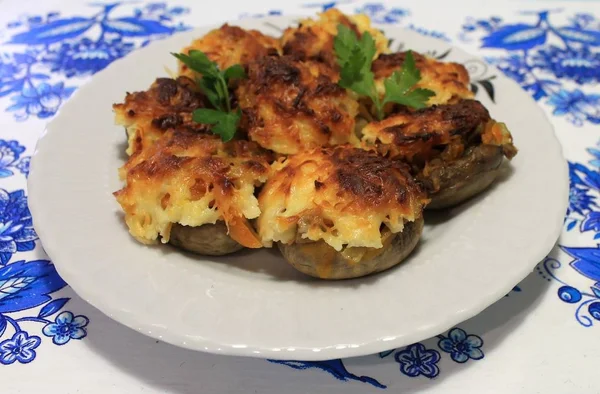 Mushrooms stuffed with vegetables baked in the oven with cheese