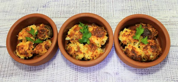 Mushrooms stuffed with vegetables baked in the oven with cheese