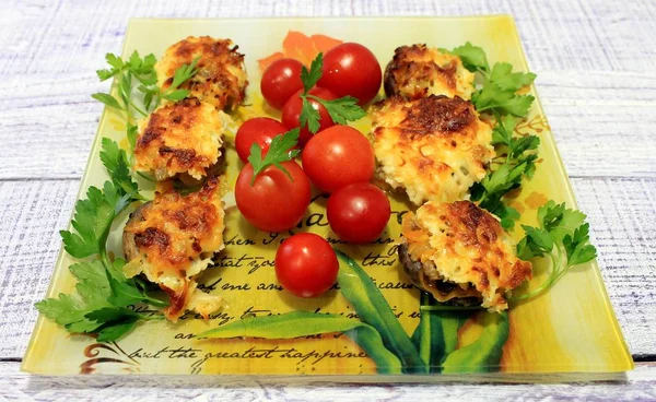 Mushrooms champignons stuffed with vegetables baked with cheese