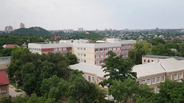 Stadsgezicht. Zicht op de school vanaf het dak van een groot huis — Stockfoto