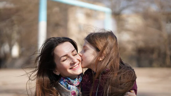 Cute Pretty Daughter Kiss Her Beautiful Mom Playground Spring Concept — Stock Photo, Image