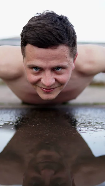 Young Man Doing Pushups Puddle Rain Playground Smiling Athlete Looks — Stock Photo, Image