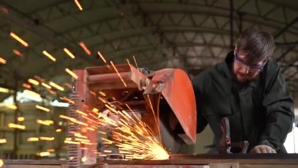 Metallo lavoratore macinazione ferro con sega elettrica durante il lavoro. Rallentamento — Video Stock