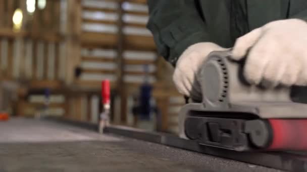 Locksmith grinds metal detail using grinder at the factory. Movement back and forth. — Stock Video