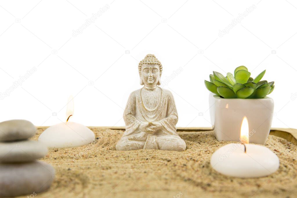 Miniature desk zen sandbox with Buddha sit in Lotus position Room for text. Sand is to recreate the essence of nature. Swirling patterns in the sand represent water, rocks are mountains. 