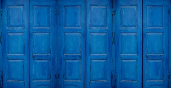 Mediterranean style style blue window sun or storm shutters closed. Background concept.