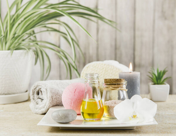 Beauty spa salon menu background minimal set. Bathroom products on light minimal wooden background. Harmonic luxury lifestyle concept. Towel, candles, bath salt, aroma massage oil in bottle.