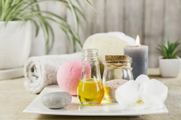 Beauty spa salon menu background minimal set. Bathroom products on light minimal wooden background. Harmonic luxury lifestyle concept. Towel, candles, bath salt, aroma massage oil in bottle.