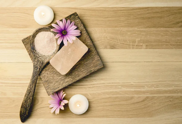 Bar of orange dry Himalayan crystal Salt Soap on wooden background with wooden spoon with pink orange Himalayan crystal Salt grains in. Alternative medicine concept. Copy space, border.