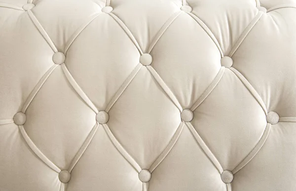 Light beige velour textile diamond pattern with buttons. Background concept. Furniture sofa cover.