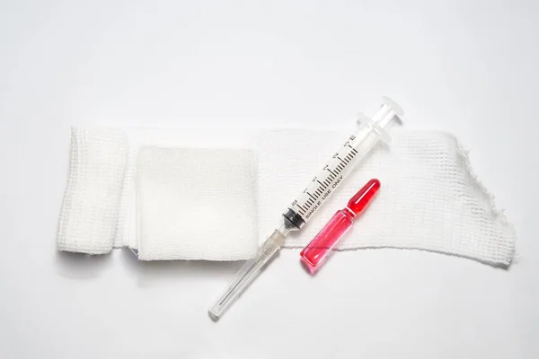 syringe ,gauze,drug ampule and needle on white background