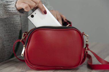 Çantası olan kadın cep telefonu.